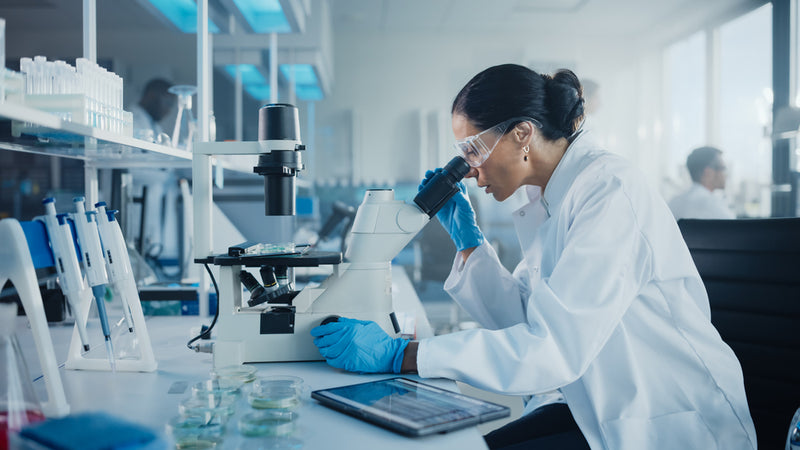 Researcher adjusting settings on a state-of-the-art refrigerated incubator in a modern laboratory.